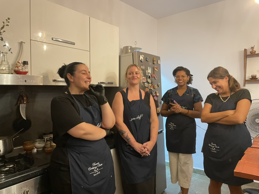 Tirana Cooking Class - Sindi with a group of students in aprons
