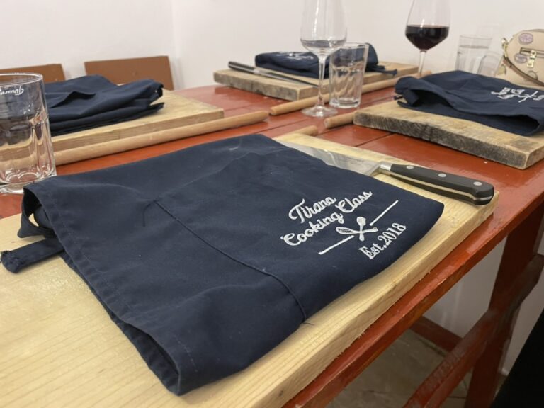 Tirana Cooking Class - table set with folded aprons and wine glasses