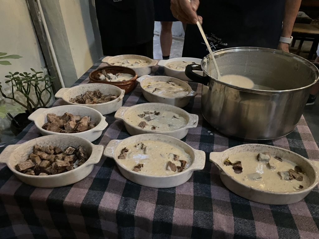 Tirana Cooking Class - dishes of tave kosi with sauce before baking